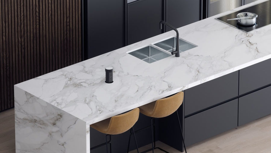 Black Point Pod raised in a white marble kitchen island