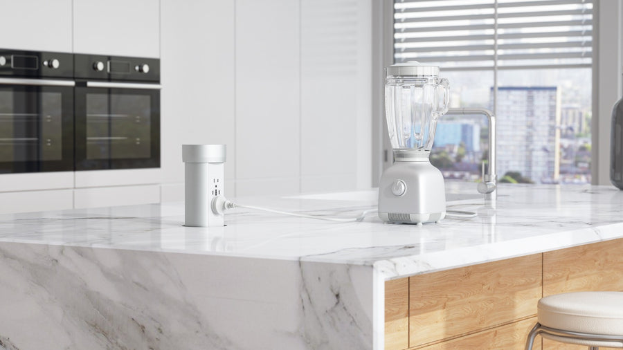 Silver Point Pod powering a blender on a white marble kitchen island